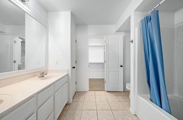 3833 Ives Way, Norman, OK 73072 - bathroom featuring toilet, tile patterned flooring, double vanity, a textured ceiling, and shower / bath combo with shower curtain