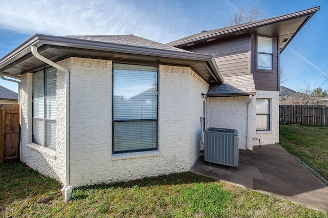 3833 Ives Way, Norman, OK 73072 - view of side of property with central AC and a shingled roof