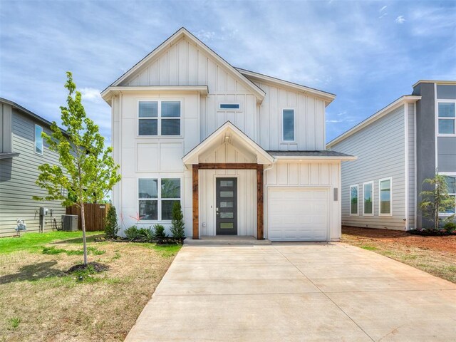 13112 Maplewood Ave, Oklahoma City, OK 73120 - view of front of home featuring board and batten siding, central AC unit, an attached garage, and concrete driveway