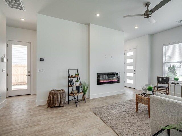 13112 Maplewood Ave, Oklahoma City, OK 73120 - living area featuring a ceiling fan, light wood finished floors, a glass covered fireplace, baseboards, and recessed lighting