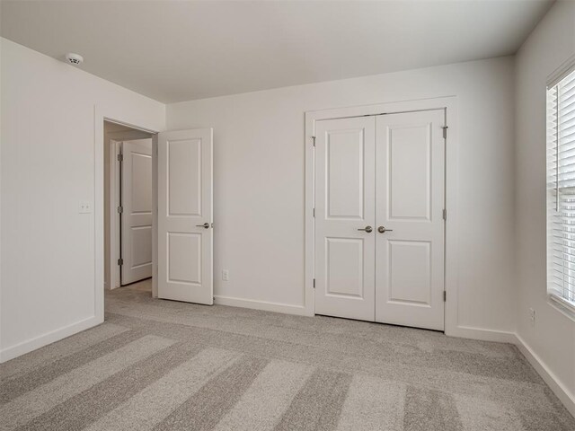 13112 Maplewood Ave, Oklahoma City, OK 73120 - unfurnished bedroom featuring light colored carpet, baseboards, and a closet