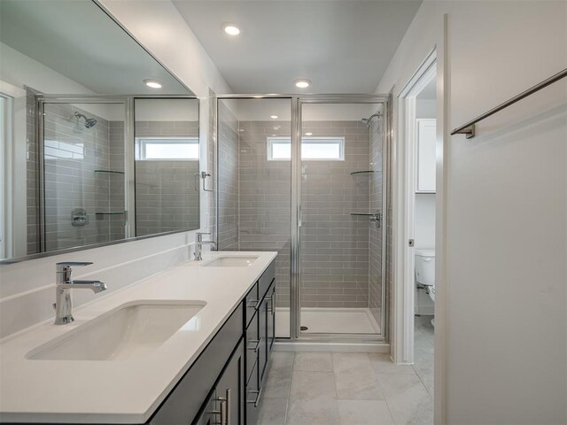 13112 Maplewood Ave, Oklahoma City, OK 73120 - full bathroom featuring tile patterned flooring, a shower stall, toilet, double vanity, and recessed lighting