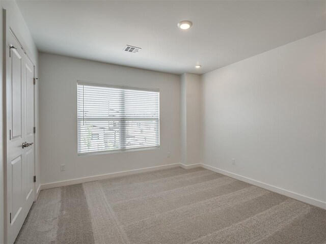 13112 Maplewood Ave, Oklahoma City, OK 73120 - spare room with baseboards, light colored carpet, and recessed lighting