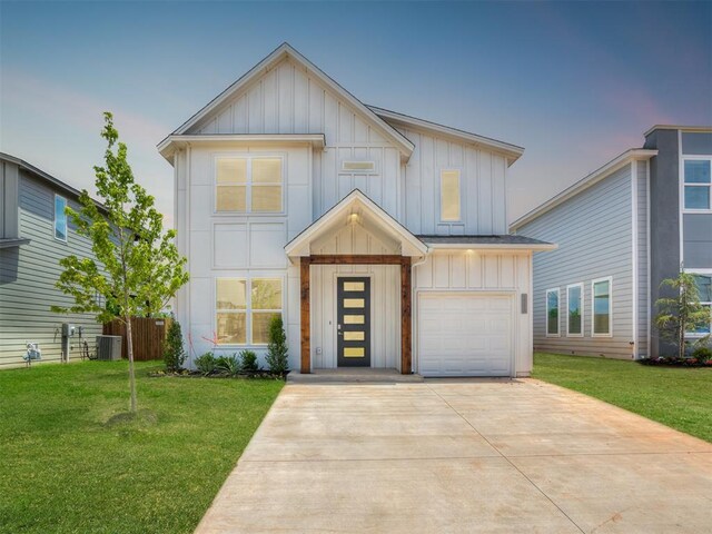 13112 Maplewood Ave, Oklahoma City, OK 73120 - view of front of property with board and batten siding, central air condition unit, a front yard, and a garage