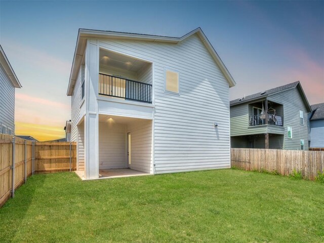 13112 Maplewood Ave, Oklahoma City, OK 73120 - back of house at dusk featuring a balcony and a patio area