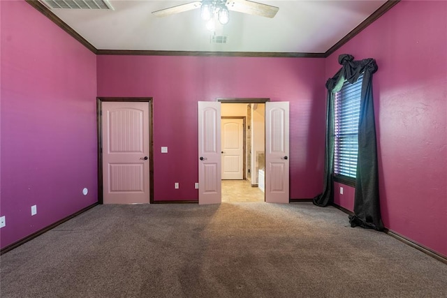 unfurnished bedroom featuring ceiling fan, ornamental molding, carpet, and visible vents