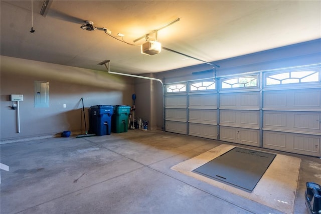 garage with electric panel and a garage door opener