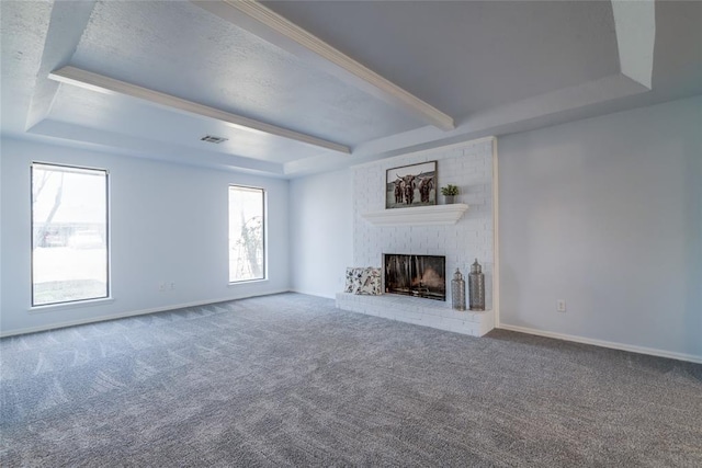 2408 Cypress Ct, Edmond, OK 73013 - unfurnished living room with a fireplace, carpet, a tray ceiling, baseboards, and beam ceiling