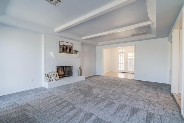 2408 Cypress Ct, Edmond, OK 73013 - unfurnished living room featuring carpet flooring, a fireplace, a chandelier, and beamed ceiling