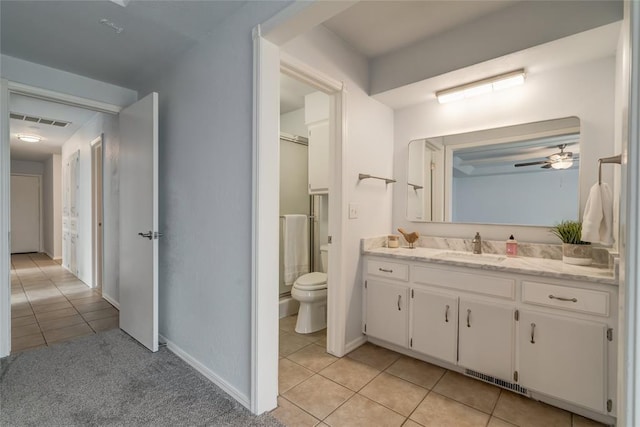 2408 Cypress Ct, Edmond, OK 73013 - full bath with tile patterned flooring, toilet, vanity, ceiling fan, and baseboards