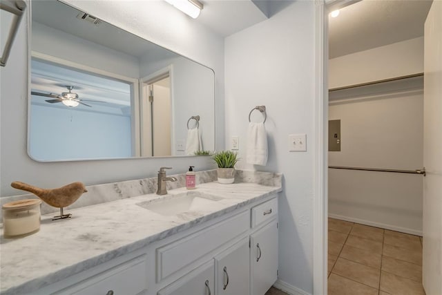 2408 Cypress Ct, Edmond, OK 73013 - bathroom featuring vanity, tile patterned flooring, a ceiling fan, and baseboards