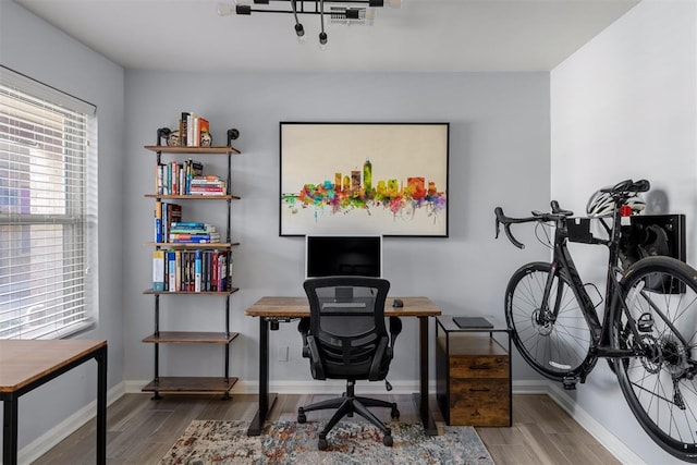 office featuring baseboards and wood finished floors