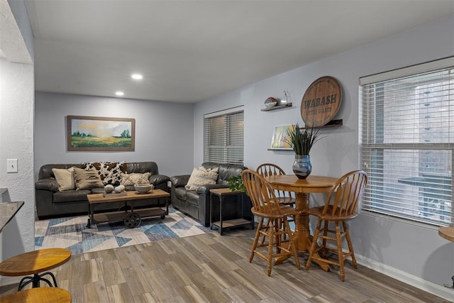 living area featuring recessed lighting, baseboards, and wood finished floors