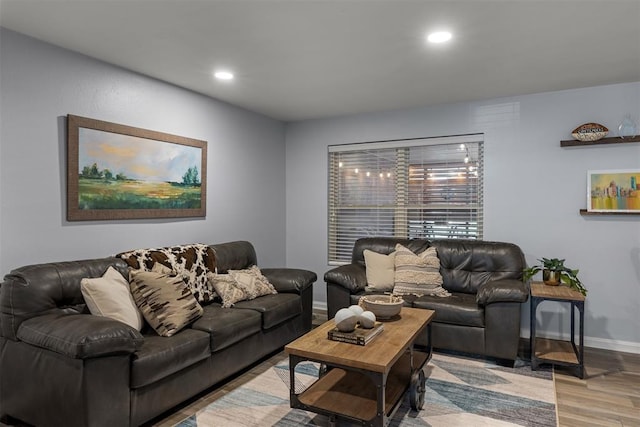 living area with baseboards, recessed lighting, and wood finished floors