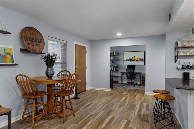 dining area with baseboards, recessed lighting, and wood finished floors