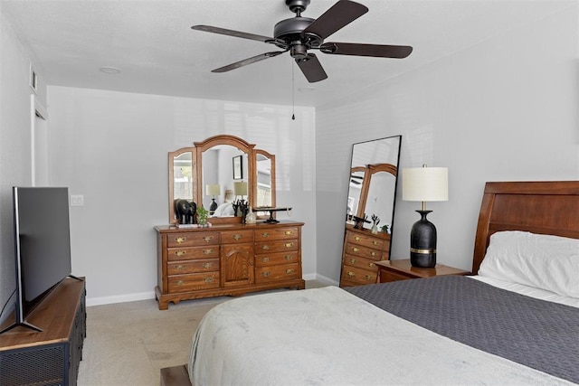 bedroom with visible vents, baseboards, light colored carpet, and ceiling fan