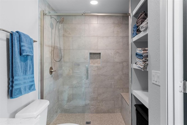 full bathroom with toilet, a shower stall, and recessed lighting