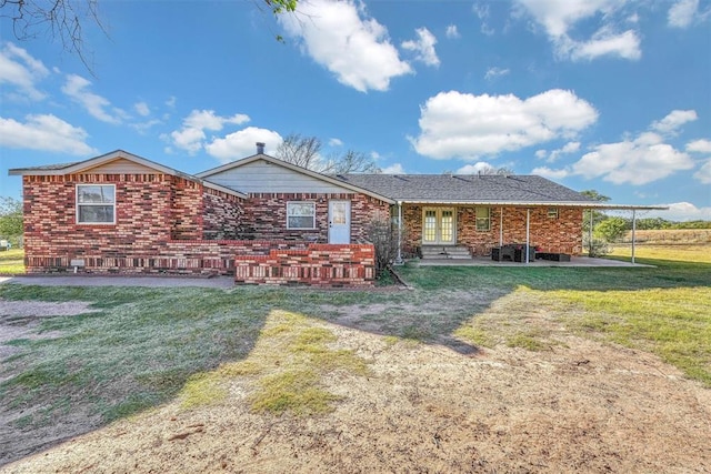 17421 E 1160th Rd, Sweetwater, OK 73666 - view of front of property featuring brick siding, french doors, and a front lawn