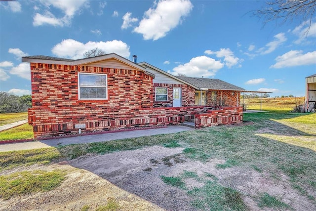 17421 E 1160th Rd, Sweetwater, OK 73666 - view of front facade with brick siding and a front yard