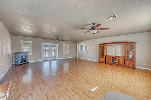 17421 E 1160th Rd, Sweetwater, OK 73666 - unfurnished living room with visible vents, french doors, light wood-type flooring, and a ceiling fan