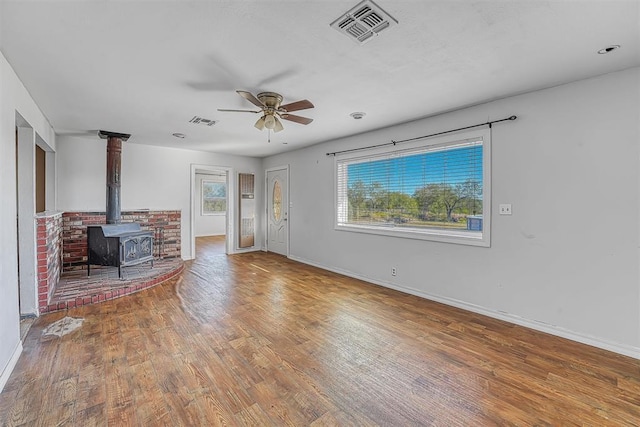 17421 E 1160th Rd, Sweetwater, OK 73666 - unfurnished living room featuring a wealth of natural light, visible vents, wood finished floors, and a ceiling fan