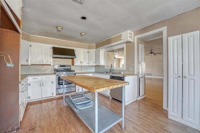 17421 E 1160th Rd, Sweetwater, OK 73666 - kitchen with range hood, light wood-style floors, stainless steel range with gas cooktop, light countertops, and dishwashing machine
