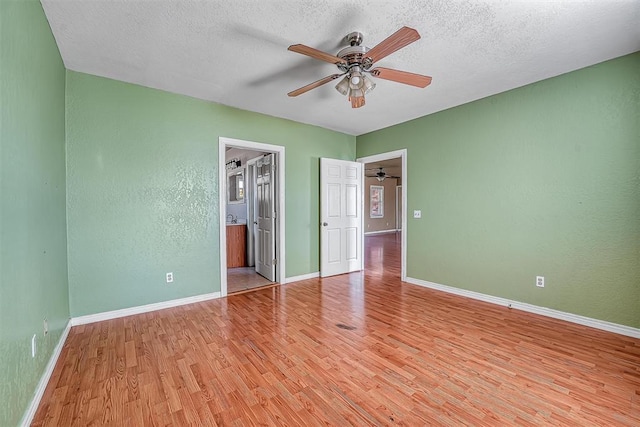 17421 E 1160th Rd, Sweetwater, OK 73666 - unfurnished bedroom with baseboards, light wood-style floors, and a textured ceiling