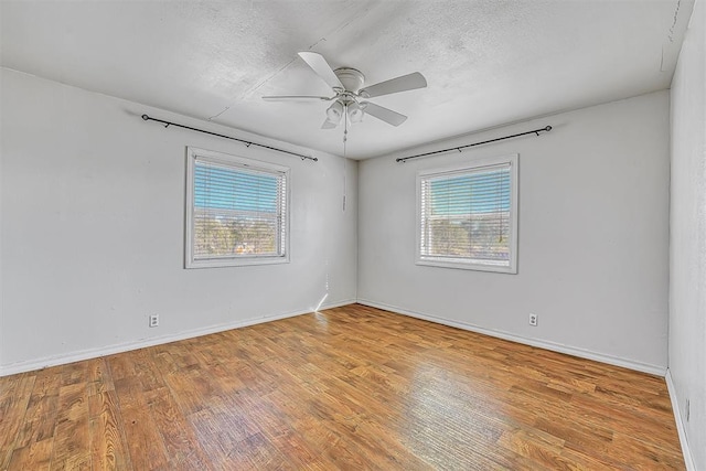 17421 E 1160th Rd, Sweetwater, OK 73666 - empty room with baseboards, wood-type flooring, a textured ceiling, and ceiling fan