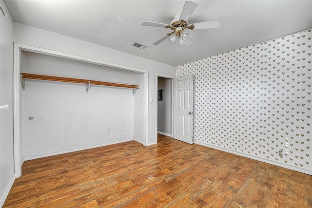 17421 E 1160th Rd, Sweetwater, OK 73666 - unfurnished bedroom featuring visible vents, wood finished floors, a closet, baseboards, and ceiling fan