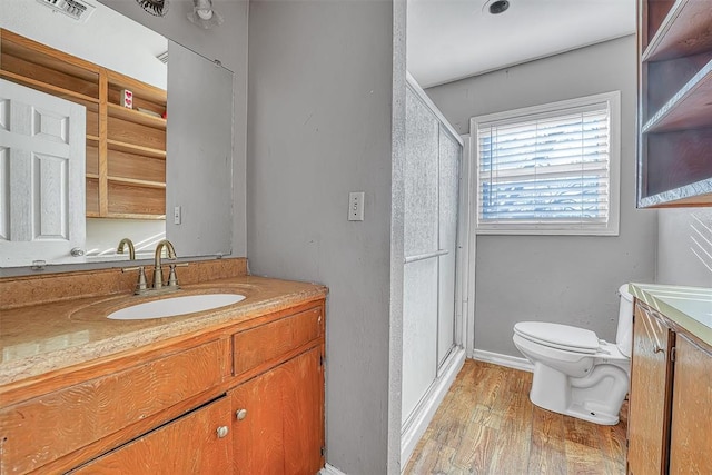 17421 E 1160th Rd, Sweetwater, OK 73666 - bathroom featuring vanity, toilet, wood finished floors, and a stall shower