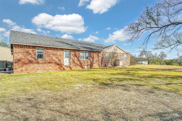 17421 E 1160th Rd, Sweetwater, OK 73666 - back of house featuring a yard, brick siding, and central AC