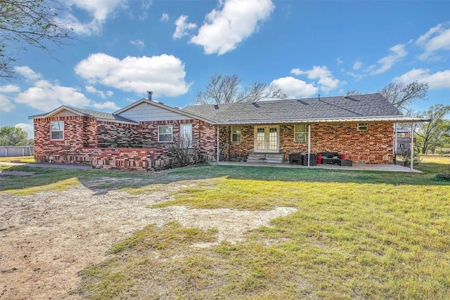 17421 E 1160th Rd, Sweetwater, OK 73666 - back of house featuring a lawn, brick siding, and a patio area