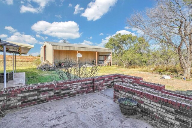 17421 E 1160th Rd, Sweetwater, OK 73666 - view of patio featuring an outbuilding