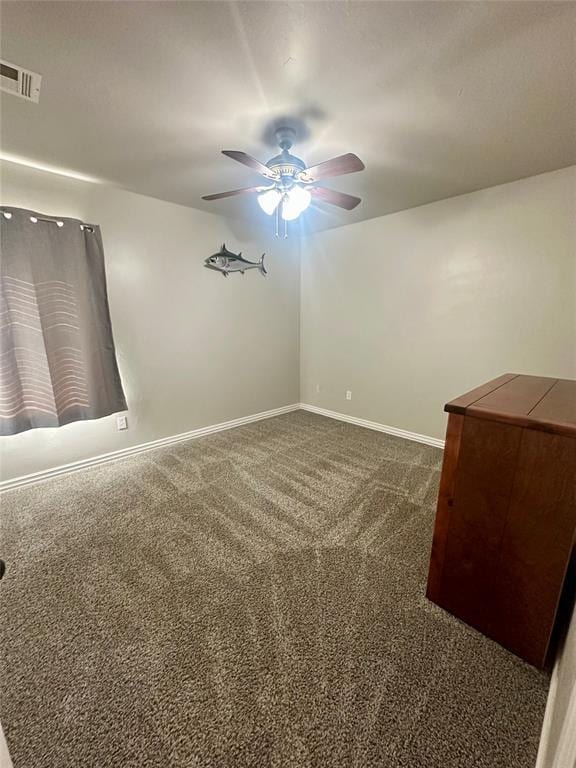 unfurnished room with visible vents, baseboards, ceiling fan, and dark colored carpet