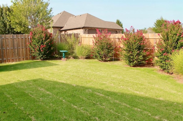 view of yard with a fenced backyard