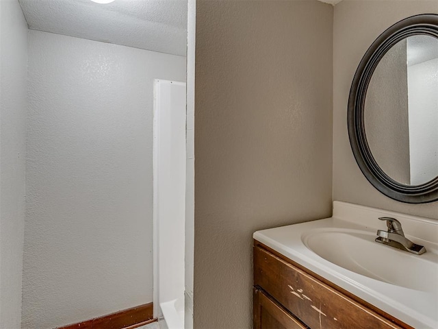 3604 NW 27th St, Oklahoma City, OK 73107 - bathroom with vanity, a textured wall, and a textured ceiling