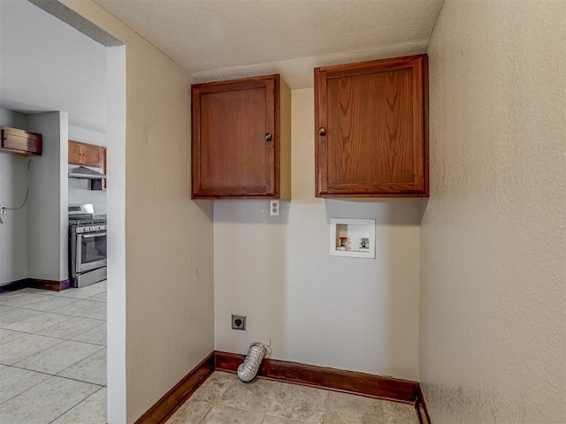 3604 NW 27th St, Oklahoma City, OK 73107 - laundry room featuring baseboards, hookup for a washing machine, light tile patterned flooring, cabinet space, and hookup for an electric dryer