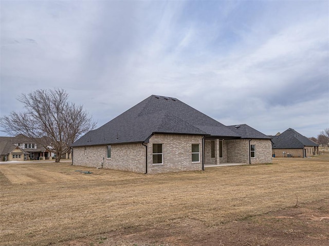 2292 NW 34th St, Newcastle, OK 73065 - rear view of house featuring a yard, brick siding, roof with shingles, and a patio area