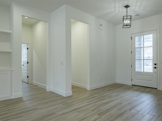 2292 NW 34th St, Newcastle, OK 73065 - unfurnished dining area with light wood finished floors, a chandelier, and baseboards