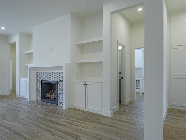2292 NW 34th St, Newcastle, OK 73065 - unfurnished living room featuring light wood-style floors, baseboards, recessed lighting, a fireplace, and built in features