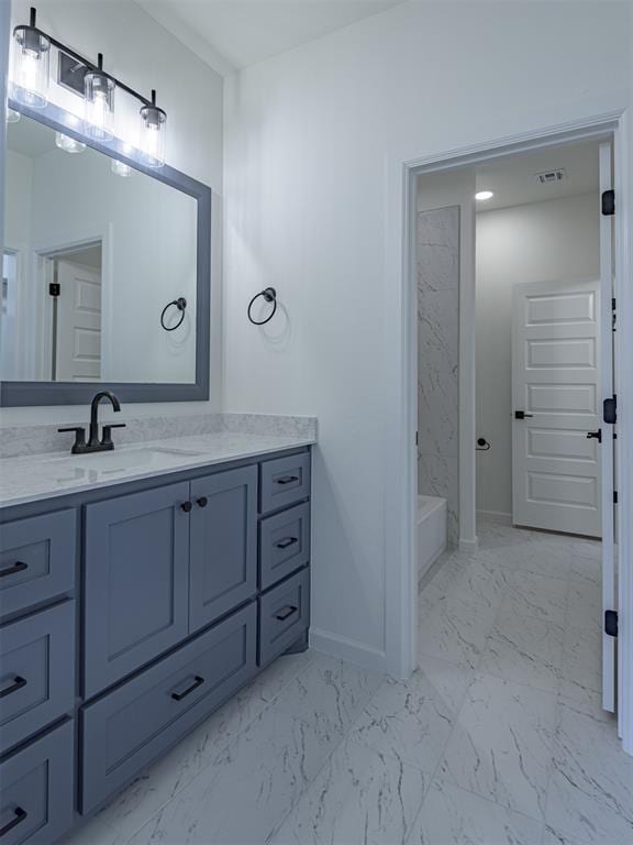 2292 NW 34th St, Newcastle, OK 73065 - bathroom featuring marble look tiles, vanity, and baseboards