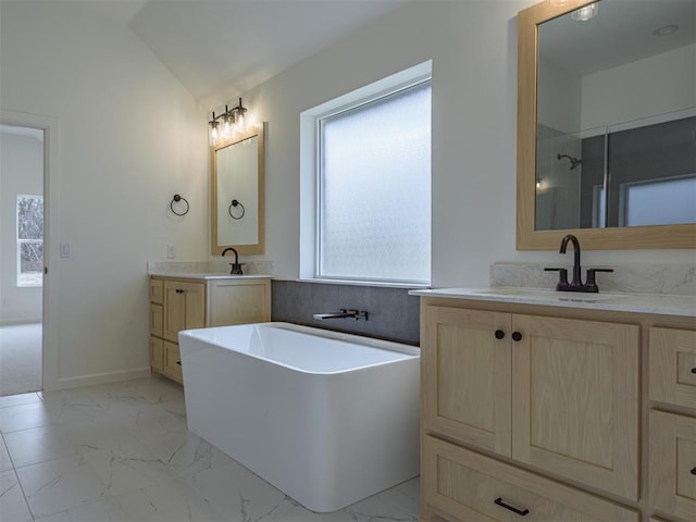 2292 NW 34th St, Newcastle, OK 73065 - full bathroom featuring marble look tile flooring, a freestanding bath, two vanities, vaulted ceiling, and a shower