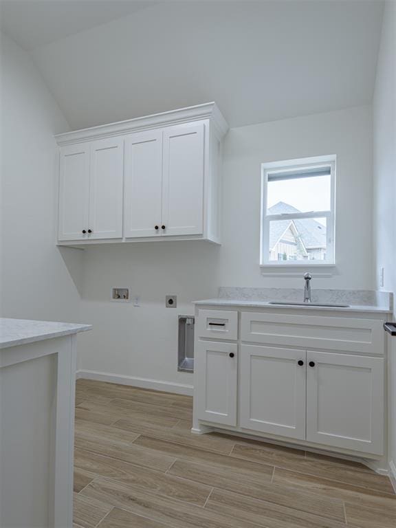 2292 NW 34th St, Newcastle, OK 73065 - laundry area with washer hookup, cabinet space, electric dryer hookup, light wood finished floors, and baseboards