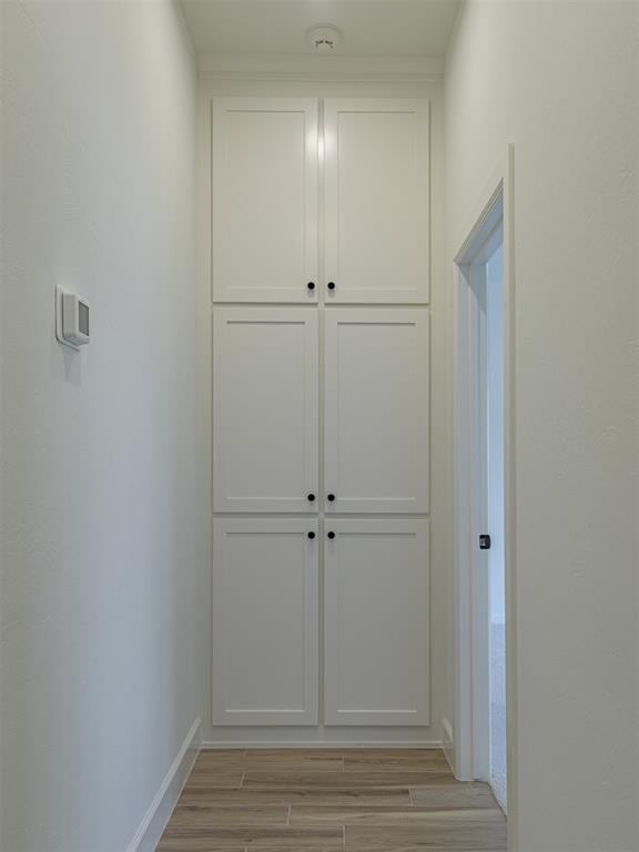 2292 NW 34th St, Newcastle, OK 73065 - hallway with light wood-style flooring and baseboards