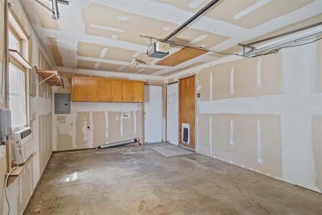 garage with electric panel and a garage door opener