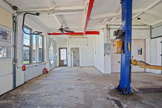 garage featuring electric panel and a ceiling fan