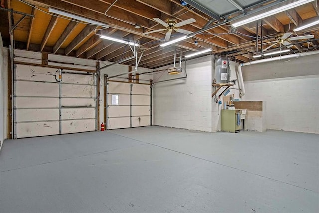 garage featuring a garage door opener and water heater