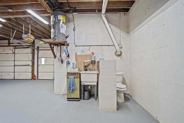 garage with water heater and a sink