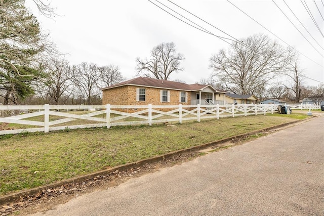 view of front of house featuring a fenced front yard and a front lawn