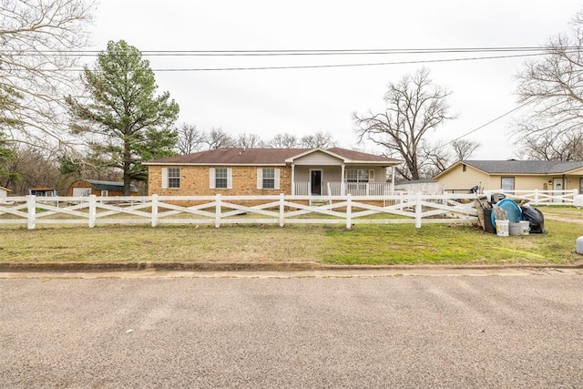 view of front facade with a fenced front yard and a front lawn